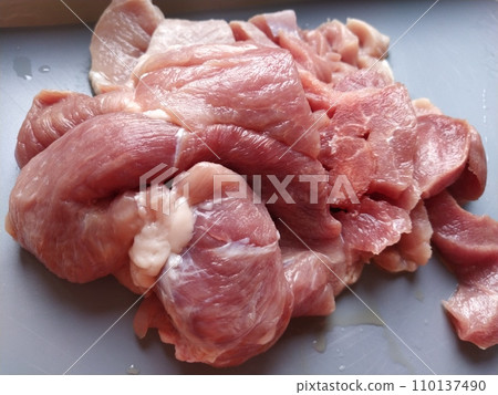A juicy large piece of pork meat on a gray surface. Meat thawed or steamed, from which blood juice flows. Delicious fresh meat for cutting and cooking A juicy large piece of pork meat on a gray surface. Meat thawed or steamed, from which blood juice flows. Delicious fresh meat for cutting and cooking 110137490