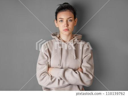 Pensive thoughtful young girl wearing sweatshirt with hood 110139762
