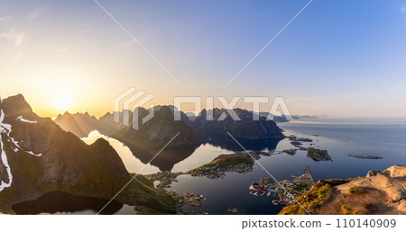 Midnight sun illuminates Lofoten peaks and Reine's serene shoreline Midnight sun illuminates Lofoten peaks and Reine's serene shoreline 110140909