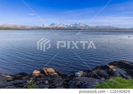 Snow-capped mountains and large boulders frame Saltfjorden near Bodo Snow-capped mountains and large boulders frame Saltfjorden near Bodo 110140929