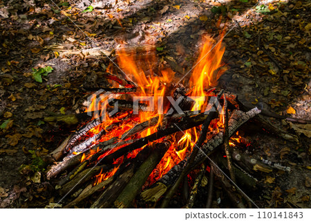 Flame of charcoal fire. Hearth for cooking and heating. Danger in forest 110141843