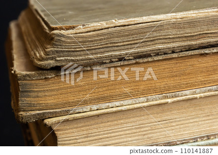 Book background. Stack of books in the library. Old yellow pages of paper books. Learning and knowledge 110141887