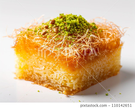 Close-up of Arabic dessert Kunafa on a white background. Close-up of Arabic dessert Kunafa on a white background. 110142651