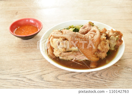 boiled slice pork leg and foot with Chinese kale in black herb soup on plate dipping chili sauce 110142763