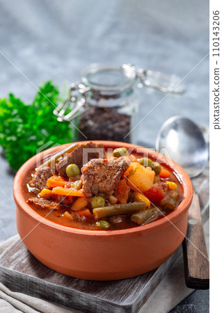 Beef stew with potato, green beans, carrot, peas and corn, in ceramic bowl, vertical, copy space Beef stew with potato, green beans, carrot, peas and corn, in ceramic bowl, vertical, copy space 110143206