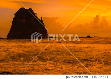 Sunset at the rocky beach in Papuma, Jember, East Java, Indonesia 110144311