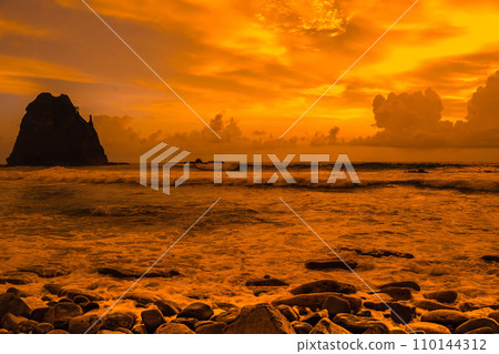 Sunset at the rocky beach in Papuma, Jember, East Java, Indonesia 110144312