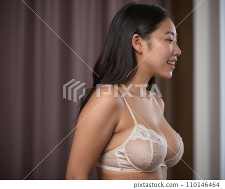 asian woman in lingerie looking out the window 110146464