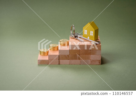 A small wooden house and keys as an idea for investing in your own home 110146557