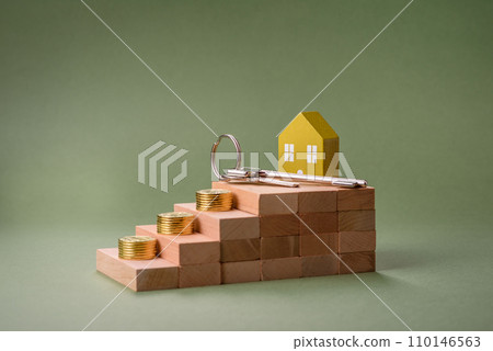 A small wooden house and keys as an idea for investing in your own home A small wooden house and keys as an idea for investing in your own home 110146563