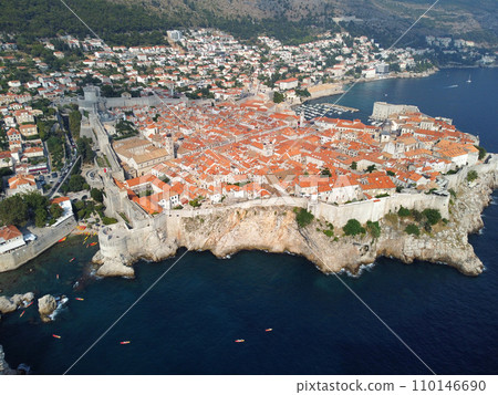 Aerial view of rooftops of Dubrovnik old historical town and Adriatic sea in Croatia. UNESCO World Heritage site, Famous tourist attraction. Vacation and adventure Aerial view of rooftops of Dubrovnik old historical town and Adriatic sea in Croatia. UNESCO World Heritage site, Famous tourist attraction. Vacation and adventure 110146690