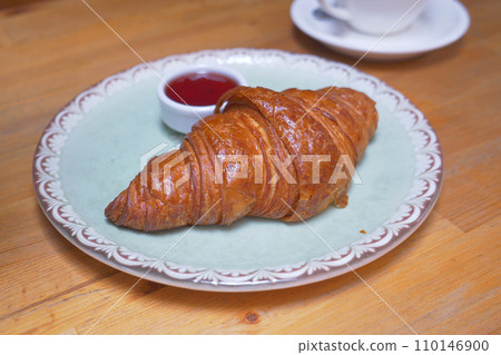 fresh baked croissant on plate with copy space fresh baked croissant on plate with copy space 110146900