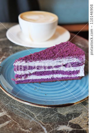 purple velvet cake with cream and coffee on table  110146908