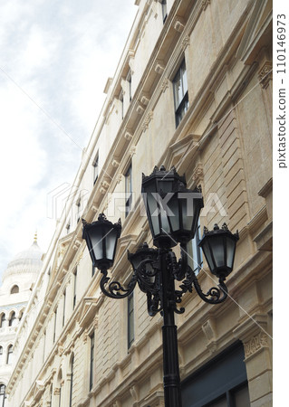Elegant street lamp surrounded by buildings  110146973
