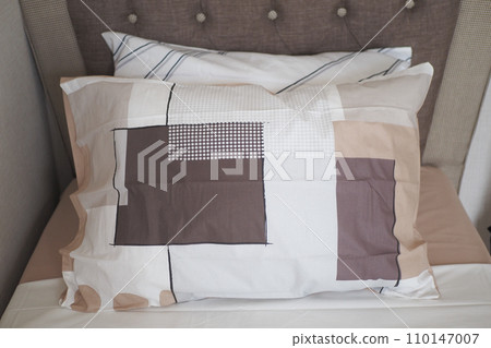 bed and brown pillows in modern bedroom 110147007