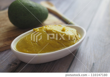 avocado and avocado pasted in a container 110147180