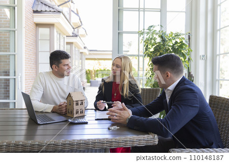 Blonde realtor listens to businessmen requirements Blonde realtor listens to businessmen requirements 110148187