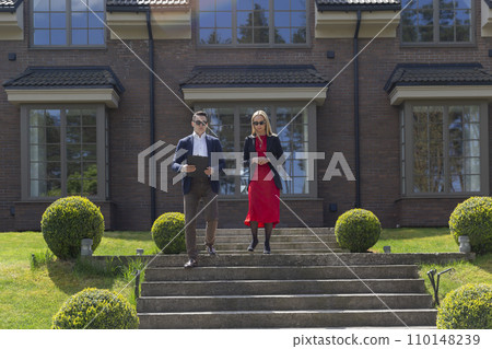 Estate agents colleagues on cottage residence steps Estate agents colleagues on cottage residence steps 110148239