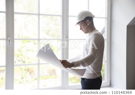 Architect studies mockup for new residence renovation 110148369