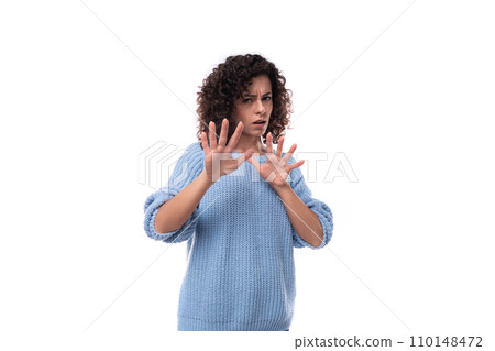 young curly brunette woman dressed in a blue sweater is brainstorming young curly brunette woman dressed in a blue sweater is brainstorming 110148472