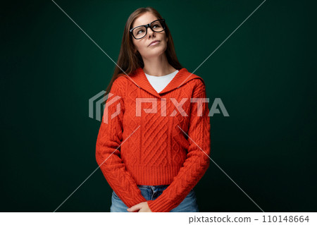 Smart Caucasian woman with brown straight hair and glasses on green background 110148664