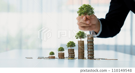 Growth coin stack with tree on top symbolize green business investment. Shrewd Growth coin stack with tree on top symbolize green business investment. Shrewd 110149548