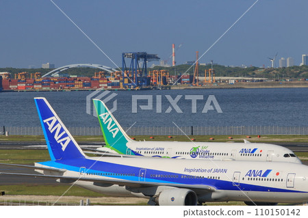 Two ANA planes resting their wings: blue and green ANA planes Two ANA planes resting their wings: blue and green ANA planes 110150142