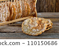 Typical South Tyrolean local crunchy flat bread, so called schuettelbrot, with wooden shelf 110150686