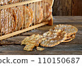 Typical South Tyrolean local crunchy flat bread, so called schuettelbrot, with wooden shelf 110150687