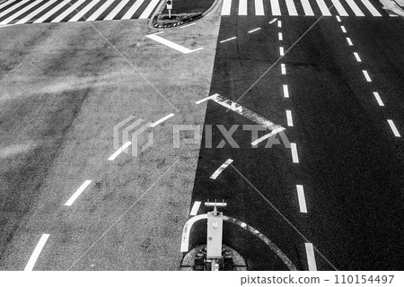 Overhead view of main road intersection, right turn lane and crosswalk, high contrast monochrome 110154497