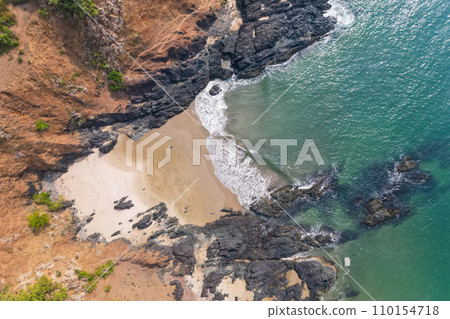 Aerial top view on tropical beach with green palm trees under sunlight Drone view in Goa 110154718