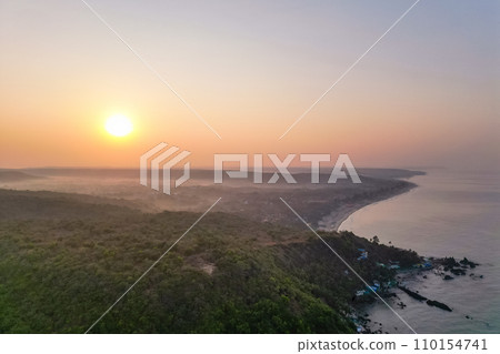 Aerial view of mountain peak and sea and sunset colorful sky from above from drone 110154741