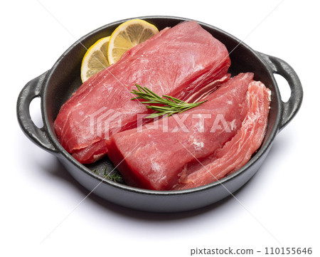 Fresh tuna Fish steak in a black ceramic dish isolated on white background Fresh tuna Fish steak in a black ceramic dish isolated on white background 110155646