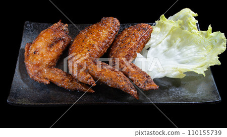 Assortment of delicious chicken wings, salt and pepper, black background, overhead view Assortment of delicious chicken wings, salt and pepper, black background, overhead view 110155739