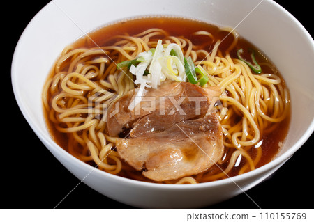 Old-fashioned soy sauce ramen, roasted menma, green onions, black background, overhead view 110155769