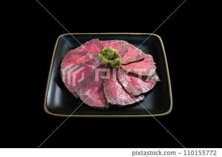 Roast beef round wasabi black background overhead view Roast beef round wasabi black background overhead view 110155772