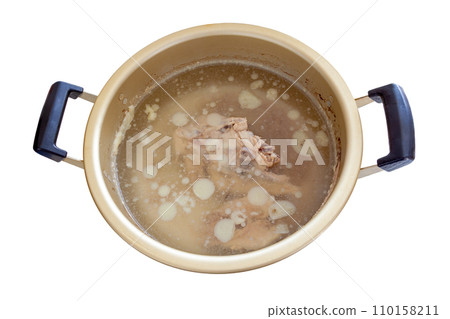A pot with a lot of chicken fat floating in the stock made from chicken bones [white background/cutout] 110158211