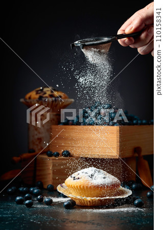 Blueberry muffins and berries in a wooden box. Blueberry muffins and berries in a wooden box. 110158341