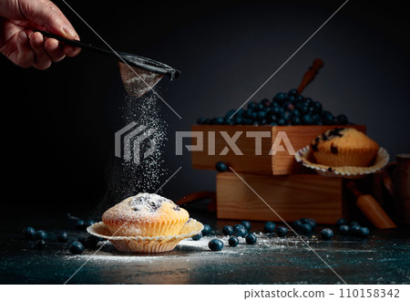 Blueberry muffins and berries in a wooden box. Blueberry muffins and berries in a wooden box. 110158342