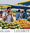 A black man bites into a mango at a tropical marche 110158679