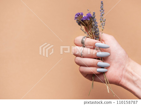 Close-up of a woman's hands with grey manicured nails 110158787