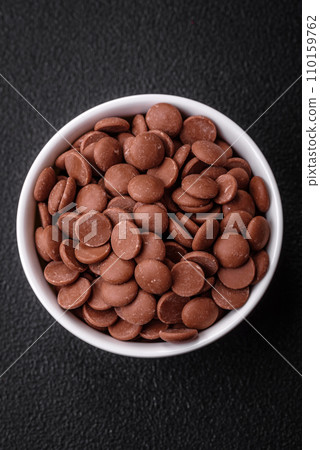 Round granules of sweet confectionery chocolate as an ingredient for preparing delicious desserts Round granules of sweet confectionery chocolate as an ingredient for preparing delicious desserts 110159762