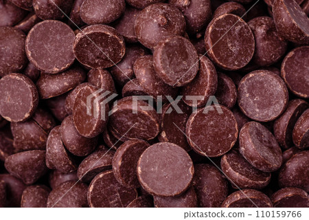 Round granules of sweet confectionery chocolate as an ingredient for preparing delicious desserts Round granules of sweet confectionery chocolate as an ingredient for preparing delicious desserts 110159766