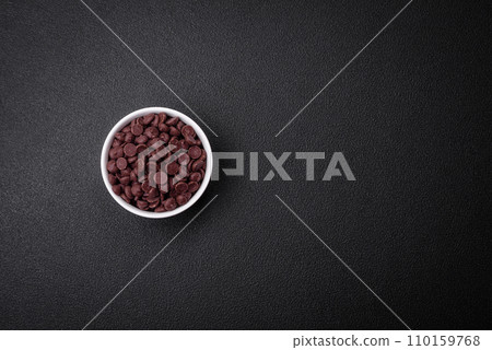 Round granules of sweet confectionery chocolate as an ingredient for preparing delicious desserts 110159768