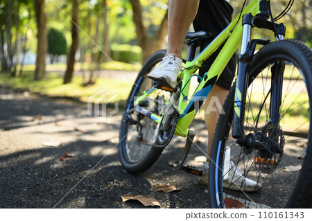Close up senior male cyclist riding bicycle in park. Health care and wellbeing concept. 110161343