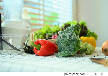 Various fresh vegetables for healthy salad on kitchen table. Organic food and healthy eating concepts. Various fresh vegetables for healthy salad on kitchen table. Organic food and healthy eating concepts. 110161356