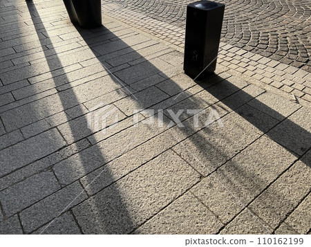 黃昏時分，陰影映在鵝卵石路面上 110162199