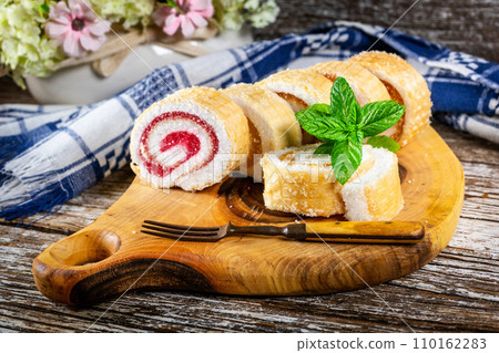 Slices of homemade sweet roll with fruit jam. Slices of homemade sweet roll with fruit jam. 110162283
