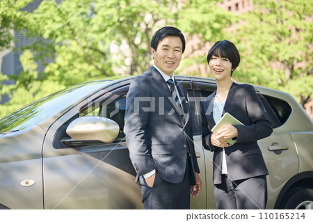 50's male office worker and 30's female office worker, business district, company car 50's male office worker and 30's female office worker, business district, company car 110165214