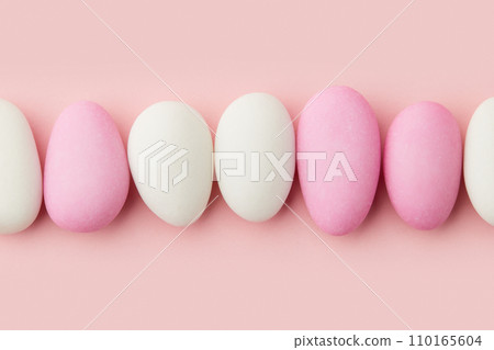 Traditional Easter Portuguese candies. White and pink sweets on pastel pink background 110165604